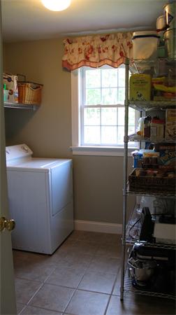 160 Barker Hill Road Townsend, MA 01469 - Photo 16 of 29 a room with water heater and wooden cabinets
