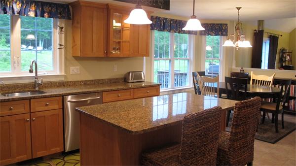 160 Barker Hill Road Townsend, MA 01469 - Photo 5 of 29 a kitchen with granite countertop a stove a sink a dining table and chairs