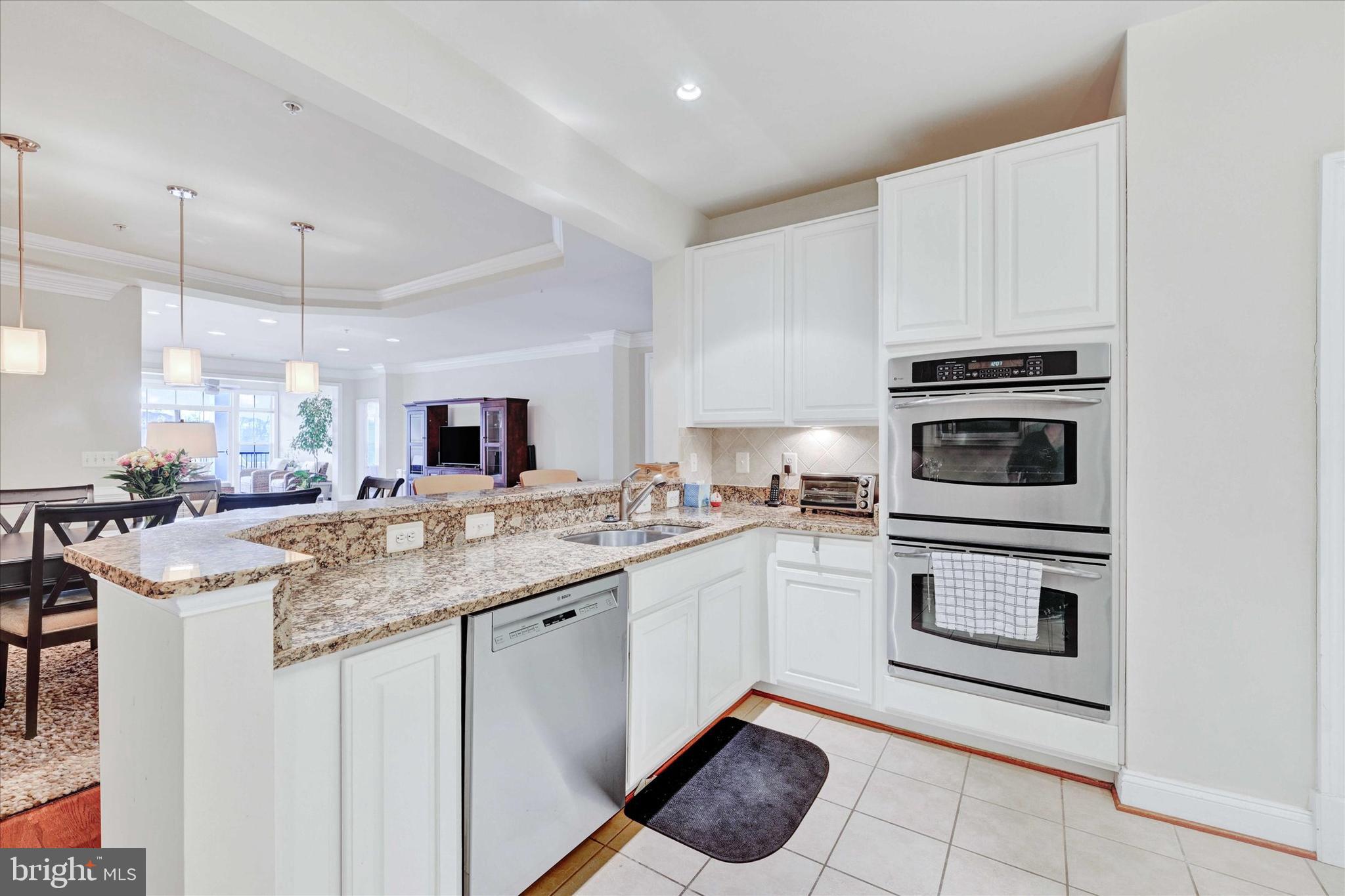 3000 Stone Cliff Drive, Unit 205 Baltimore, MD 21209 - Photo 15 of 28 a kitchen with a sink and cabinets