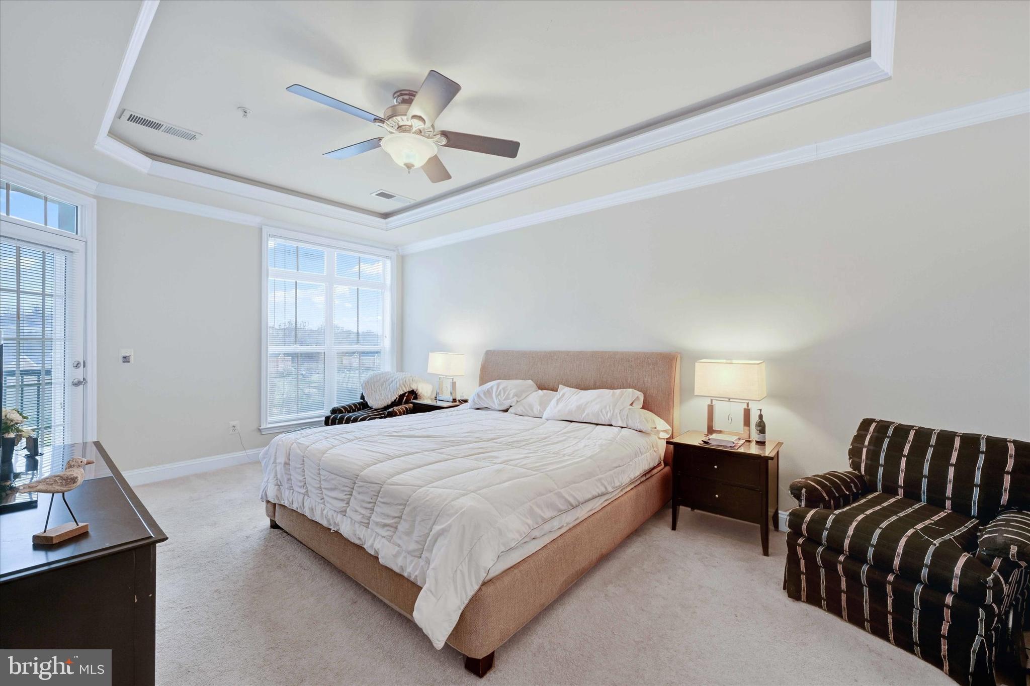 3000 Stone Cliff Drive, Unit 205 Baltimore, MD 21209 - Photo 16 of 28 a bedroom with bed and a chandelier