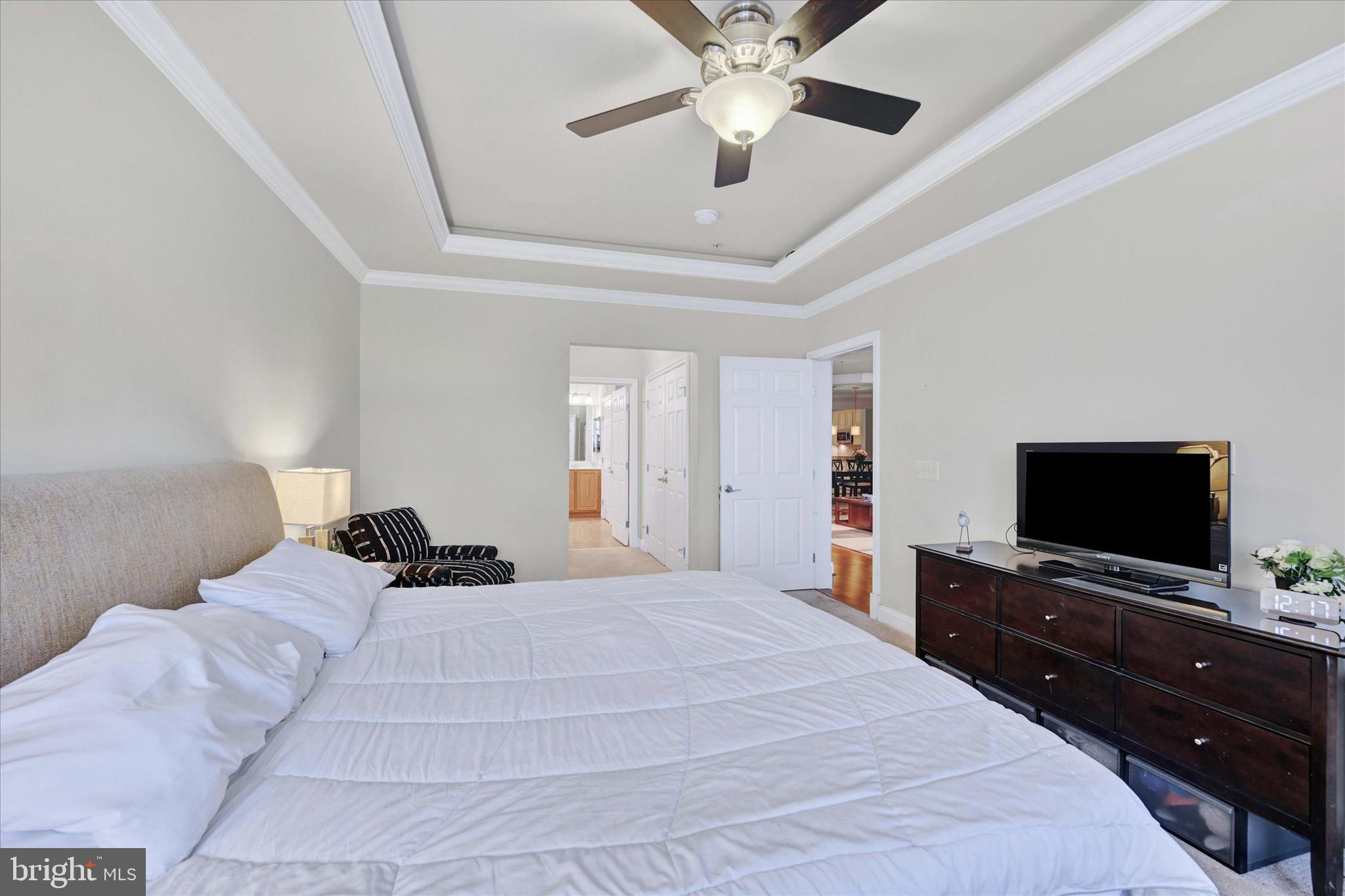 3000 Stone Cliff Drive, Unit 205 Baltimore, MD 21209 - Photo 17 of 28 a bedroom with a bed and a flat screen tv