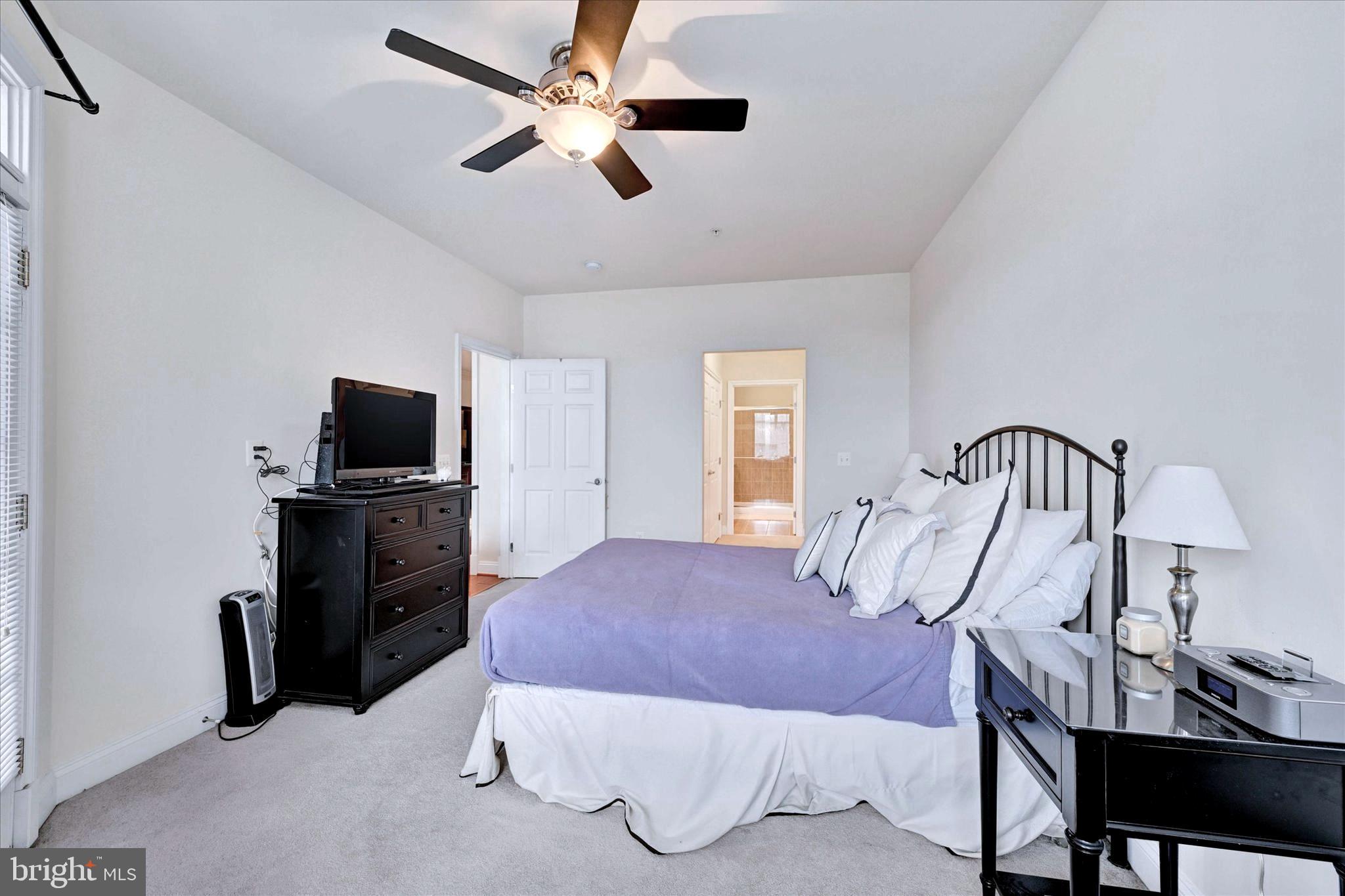 3000 Stone Cliff Drive, Unit 205 Baltimore, MD 21209 - Photo 21 of 28 a bedroom with a bed and a television