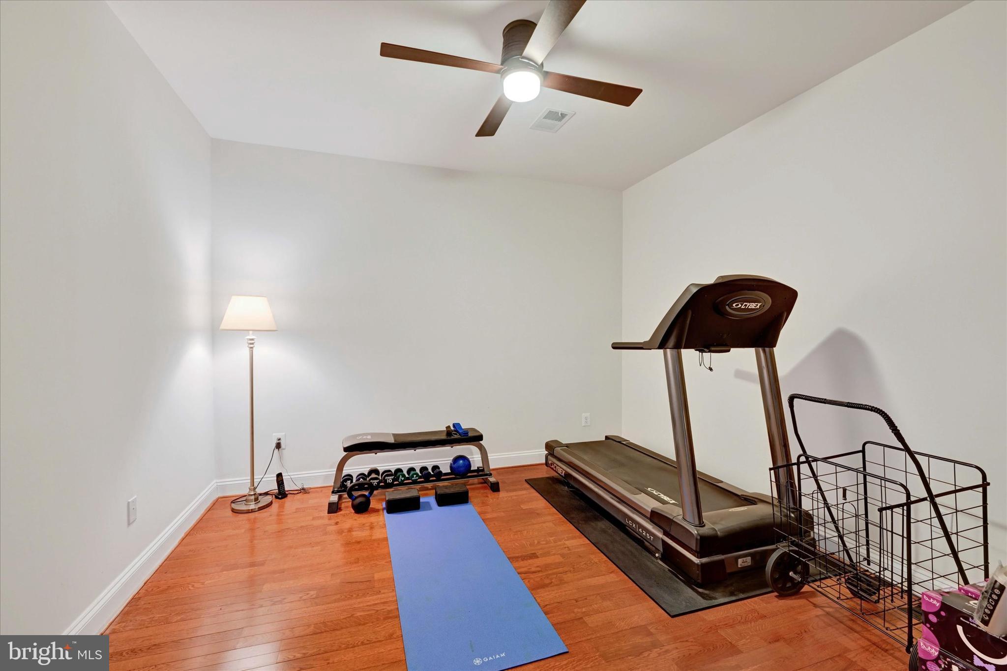 3000 Stone Cliff Drive, Unit 205 Baltimore, MD 21209 - Photo 23 of 28 a room with gym equipment and a table