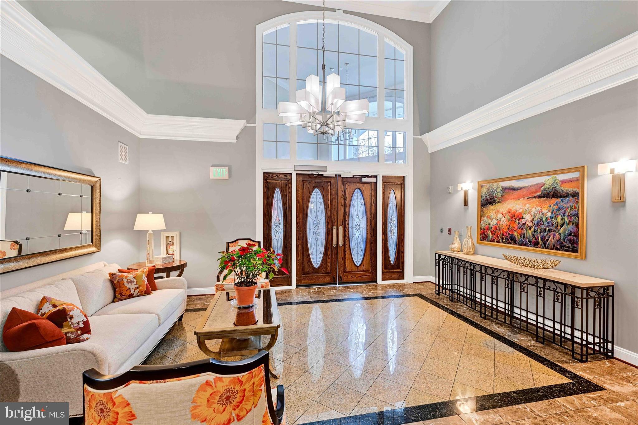 3000 Stone Cliff Drive, Unit 205 Baltimore, MD 21209 - Photo 25 of 28 a view of a living room with furniture and a large window