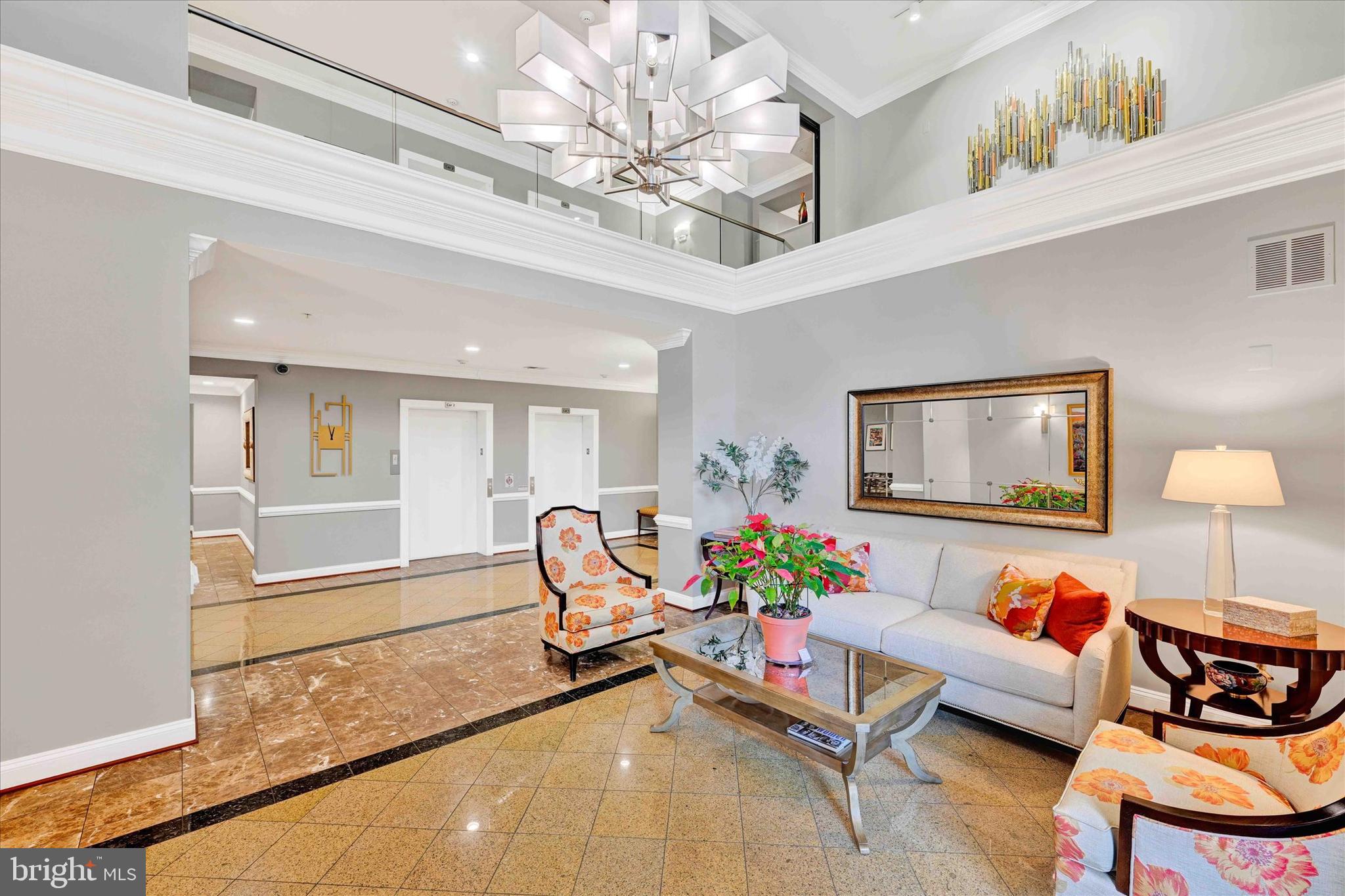3000 Stone Cliff Drive, Unit 205 Baltimore, MD 21209 - Photo 26 of 28 a living room with furniture and a chandelier