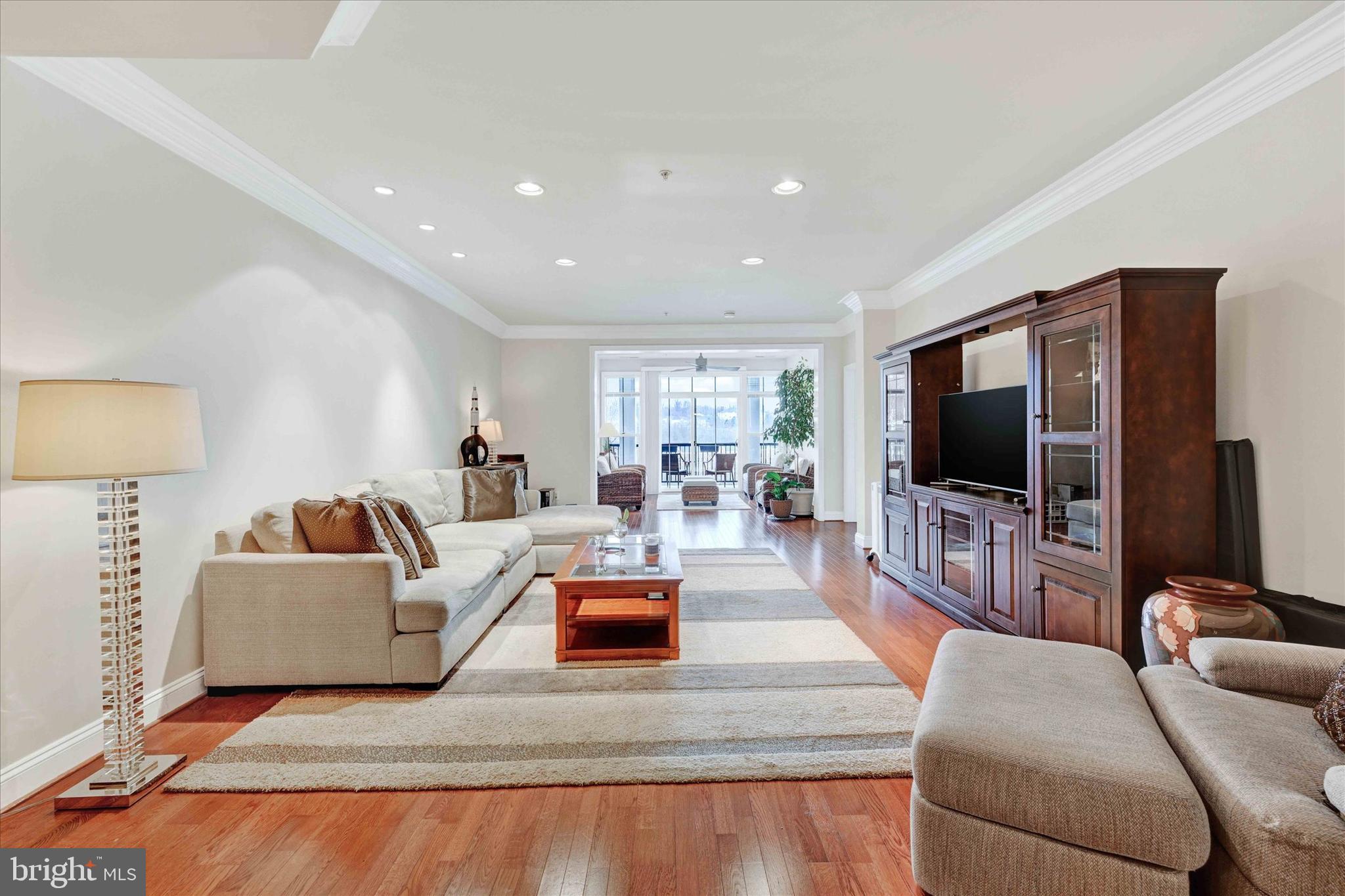 3000 Stone Cliff Drive, Unit 205 Baltimore, MD 21209 - Photo 3 of 28 a living room with furniture and a flat screen tv