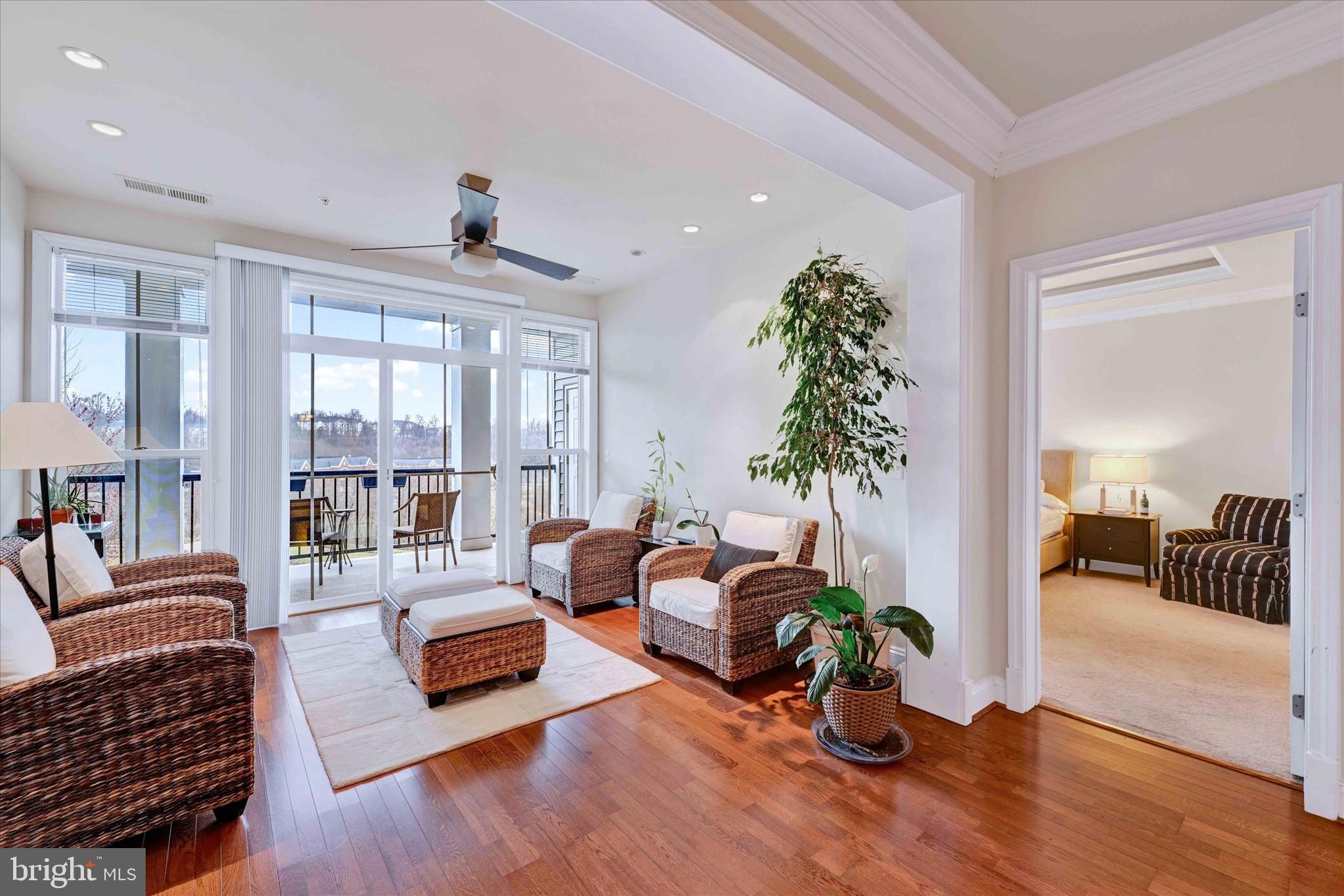 3000 Stone Cliff Drive, Unit 205 Baltimore, MD 21209 - Photo 4 of 28 a living room with furniture floor to ceiling window and potted plant