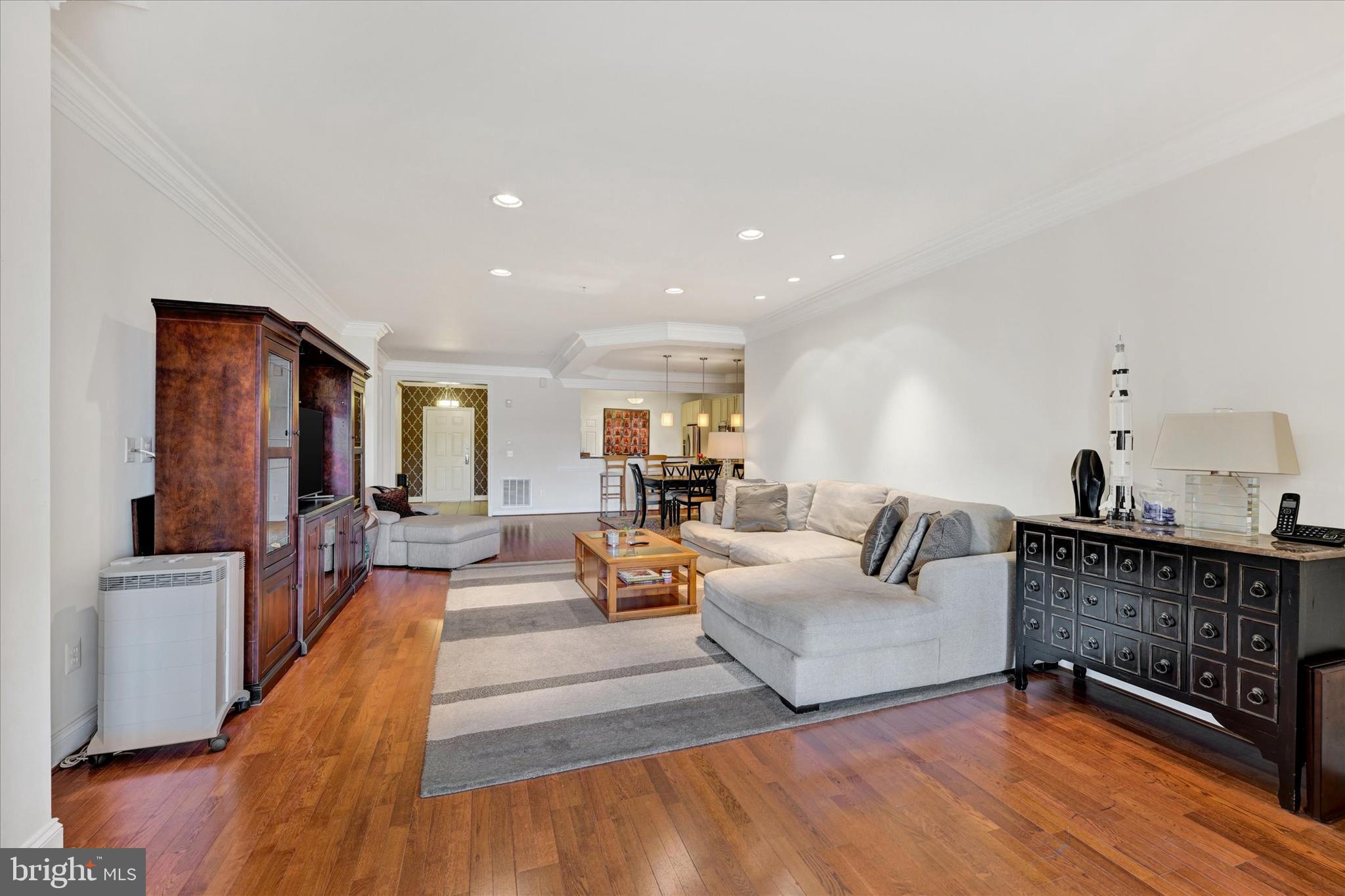 3000 Stone Cliff Drive, Unit 205 Baltimore, MD 21209 - Photo 8 of 28 a living room with furniture and a table