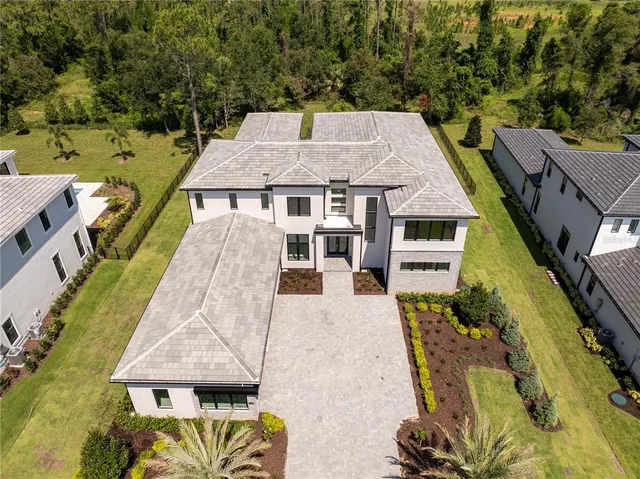 an aerial view of a house with swimming pool