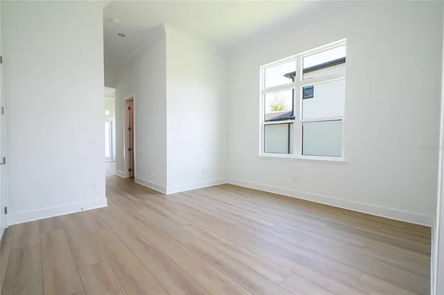 a view of an empty room and wooden floor
