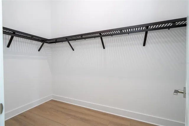 a view of a room with wooden floor and windows