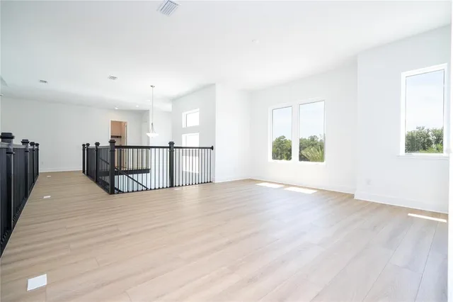 a spacious bathroom with a shower sink and mirror
