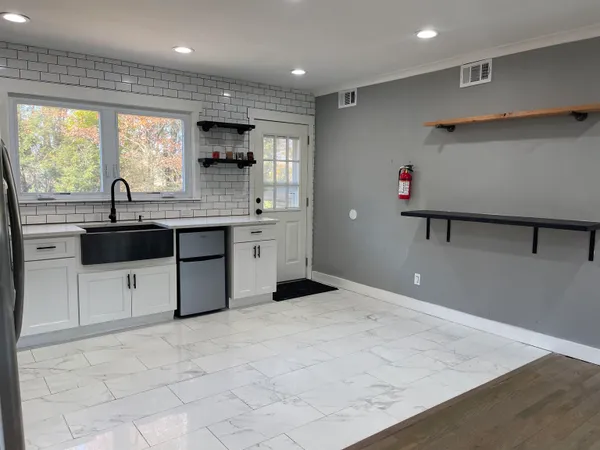 a kitchen with stainless steel appliances granite countertop a sink and a stove