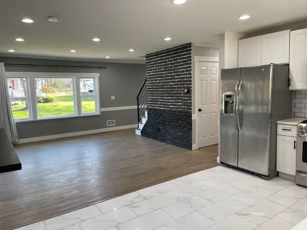 an empty room with wooden floor and fireplace