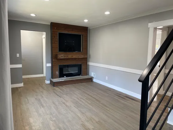 wooden floor in an empty room with a fireplace