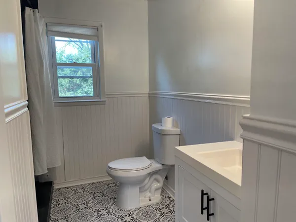 a white toilet sitting next to a bathroom sink