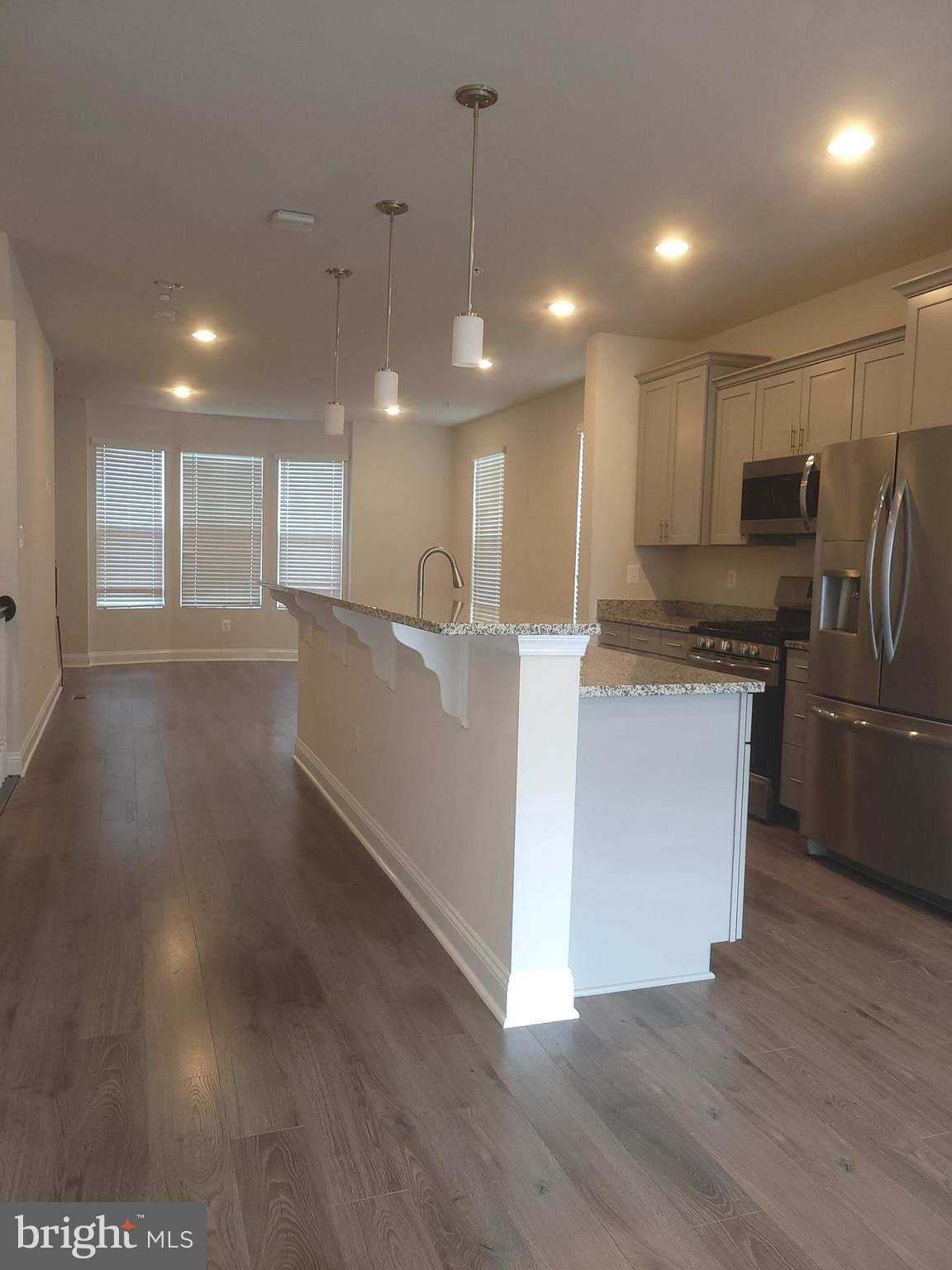 7111 Tyndale Way Hanover, MD 21076 - Photo 7 of 59 Spacious Kitchen island & view to the living room