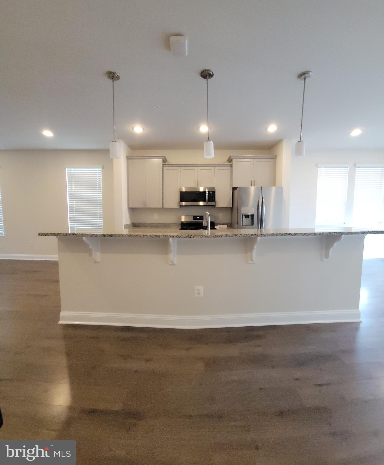 7111 Tyndale Way Hanover, MD 21076 - Photo 8 of 59 Kitchen island with pendant lights