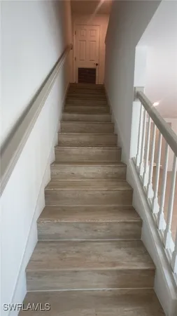 en empty room with wooden floor and ceiling fan