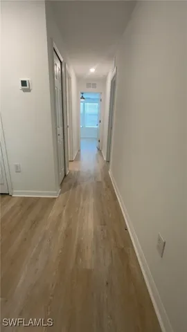 an empty room with a window and a ceiling fan