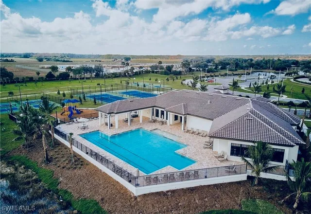 an aerial view of a house with a garden and lake view