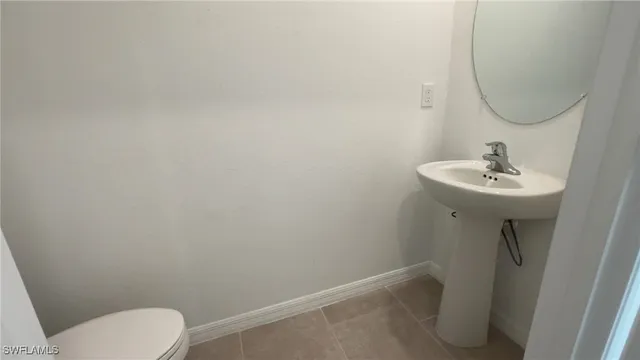 a bathroom with a sink toilet and a mirror