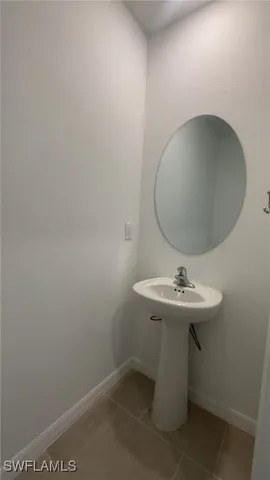 a bathroom with a sink toilet and mirror