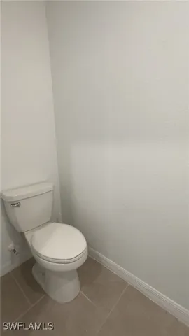a white toilet sitting next to a white sink