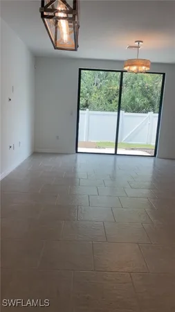 an empty room with large windows