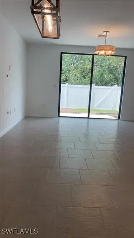 an empty room with large windows