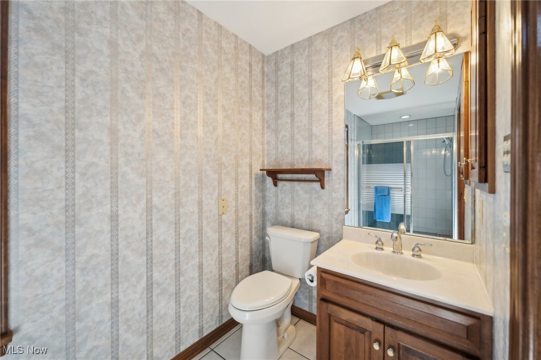 43301 Parsons Road Oberlin, OH 44074 - Photo 25 of 47 Full bathroom featuring tile patterned flooring, vanity, a stall shower, and toilet
