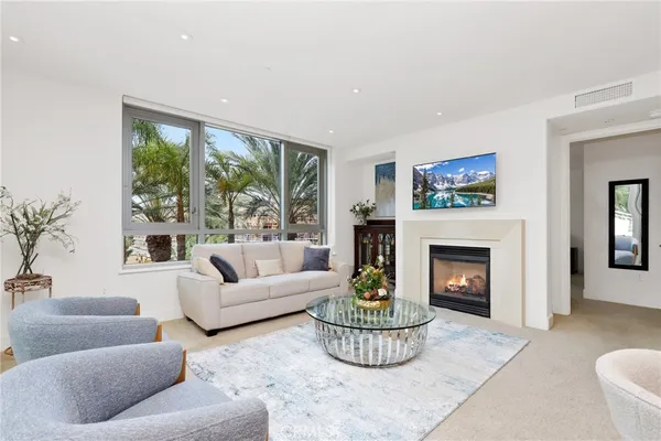 a living room with furniture a window and a fireplace