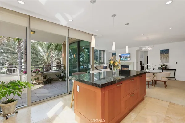 a kitchen with large windows and refrigerator
