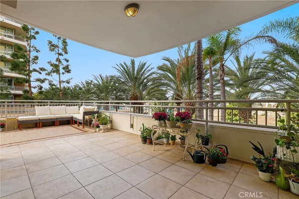 a terrace with outdoor seating and city view