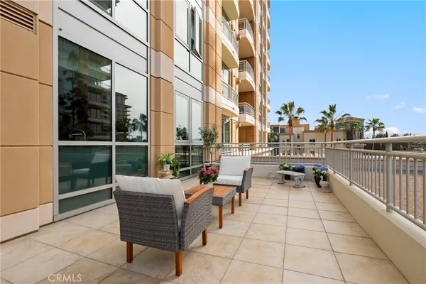a view of a patio with couches and table and chairs and potted plants