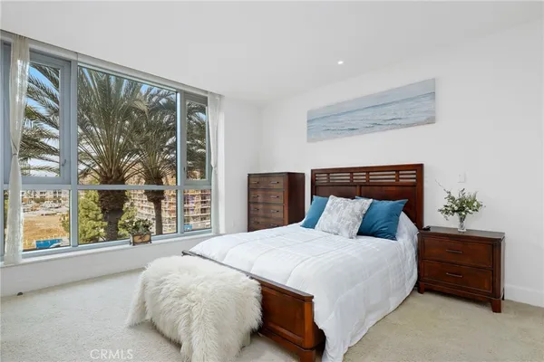 a bed sitting in a bedroom next to a window
