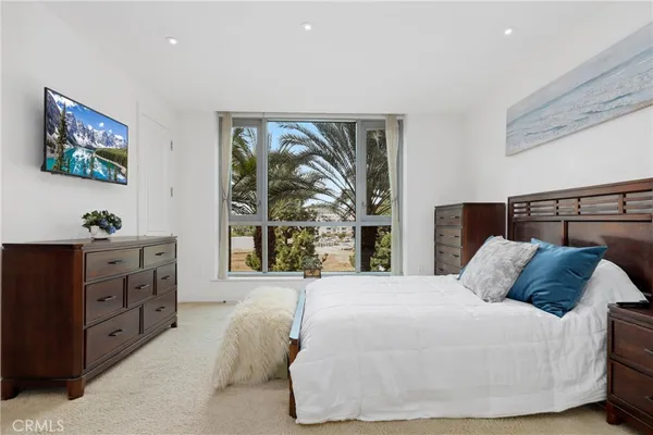 a bedroom with a large bed and a window