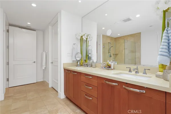 a bathroom with a double vanity sink and a mirror