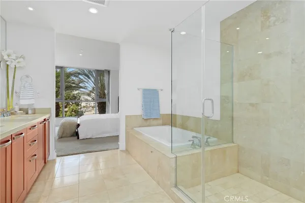 a bathroom with a tub a sink and a shower
