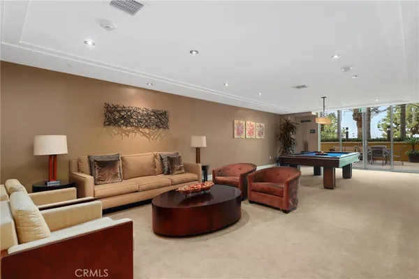 a room with pool table and windows