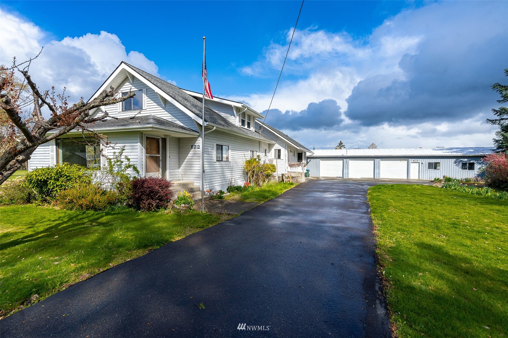 a view of a house with a yard and pathway