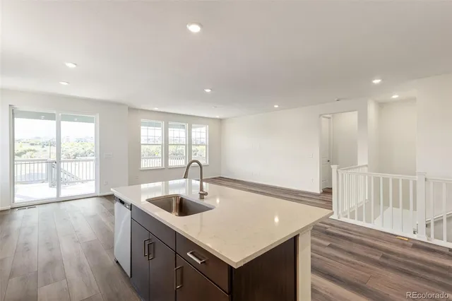 a kitchen with kitchen island a sink appliances and a large window