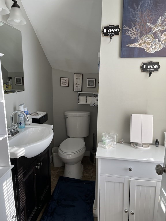 23 Preston Street Springfield, MA 01109 - Photo 12 of 24 a bathroom with a toilet a sink and a mirror