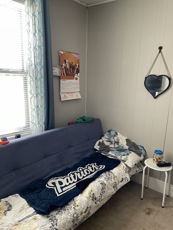23 Preston Street Springfield, MA 01109 - Photo 23 of 24 a bed sitting in a bedroom next to a window