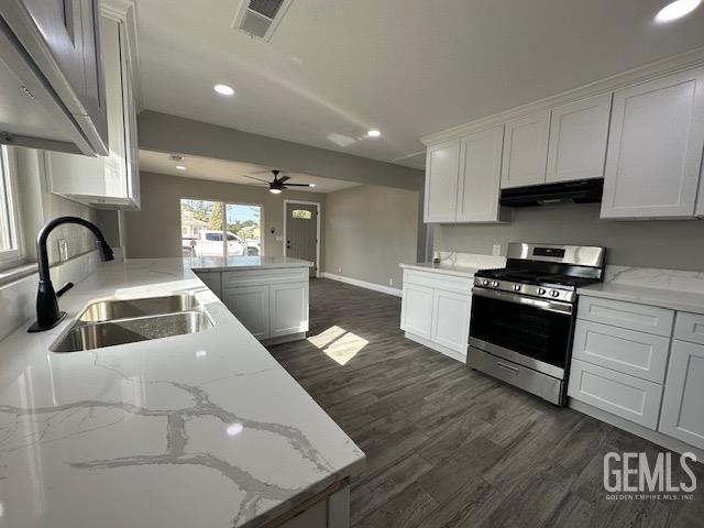 Undisclosed Address Delano, CA 93215 - Photo 6 of 15 a kitchen with granite countertop a stove a sink and a refrigerator