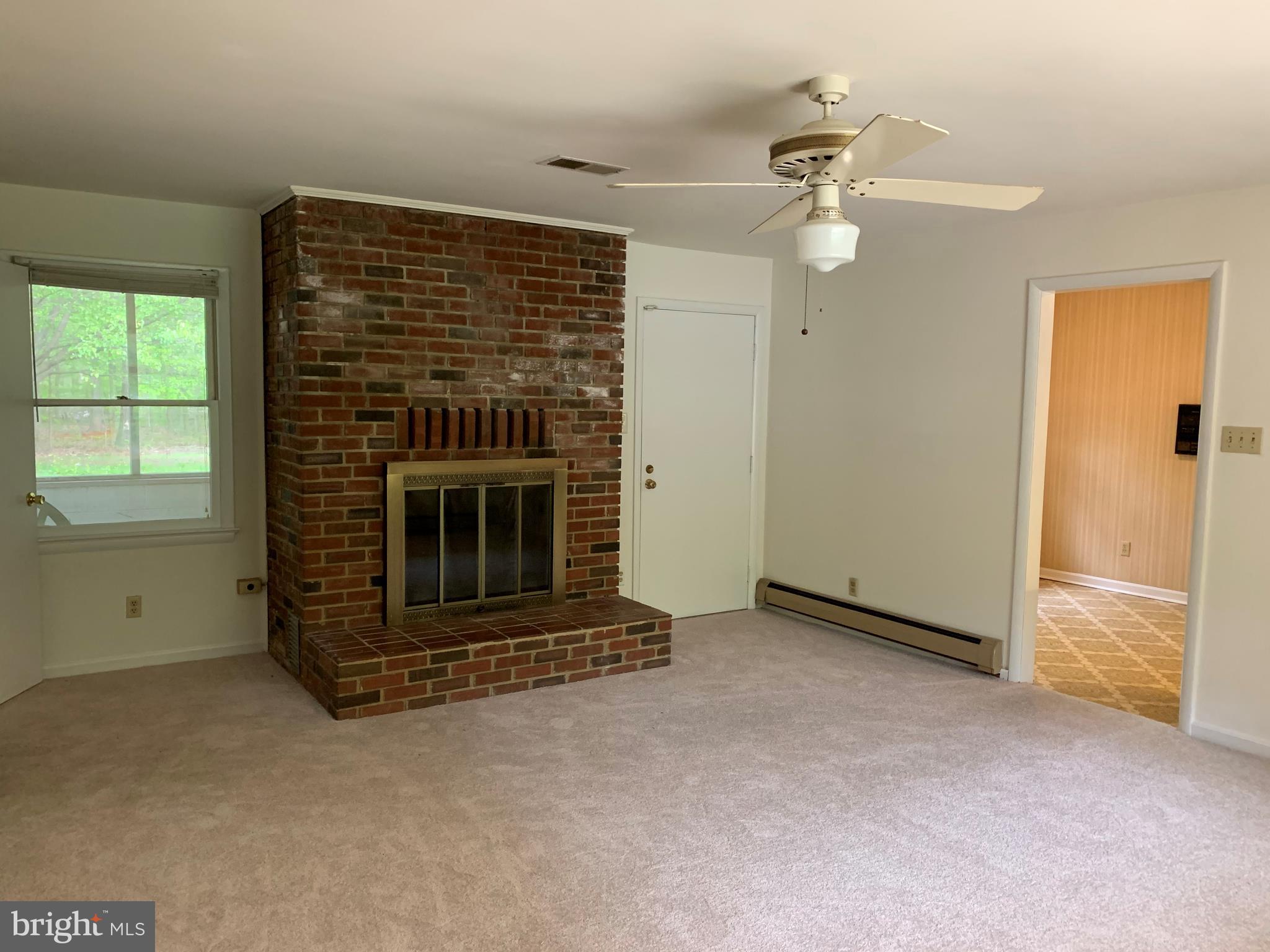 4515 Shirley Gate Road Fairfax, VA 22030 - Photo 13 of 26 an empty room with windows fireplace and fans