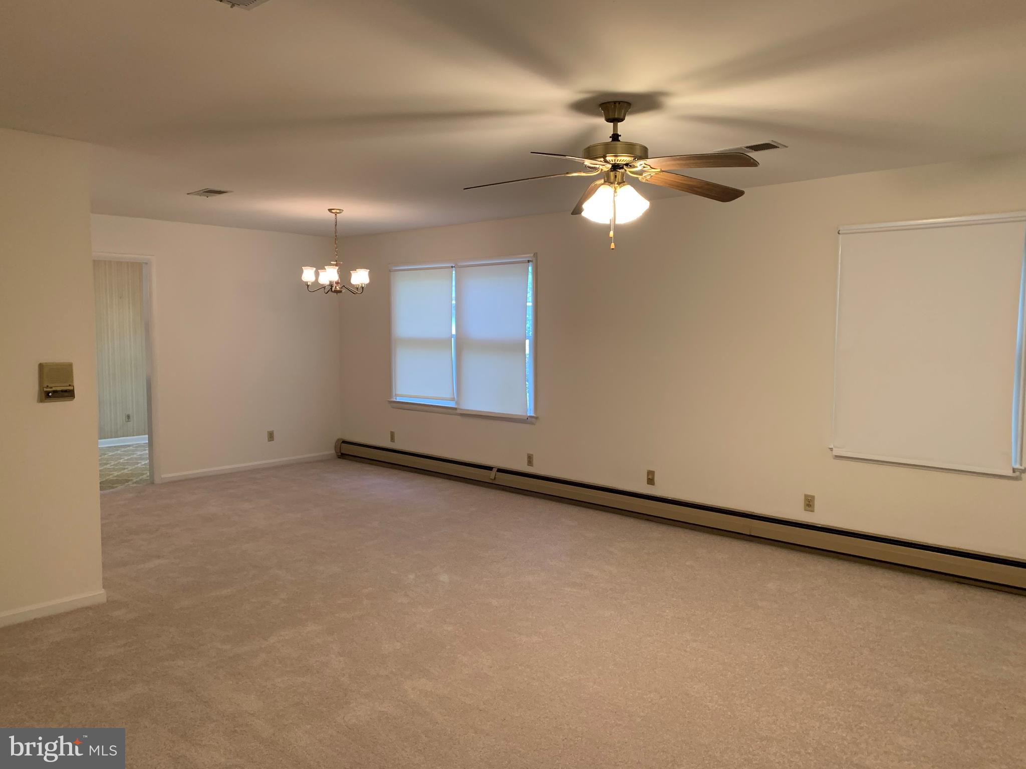 4515 Shirley Gate Road Fairfax, VA 22030 - Photo 17 of 26 an empty room with chandelier fan and windows