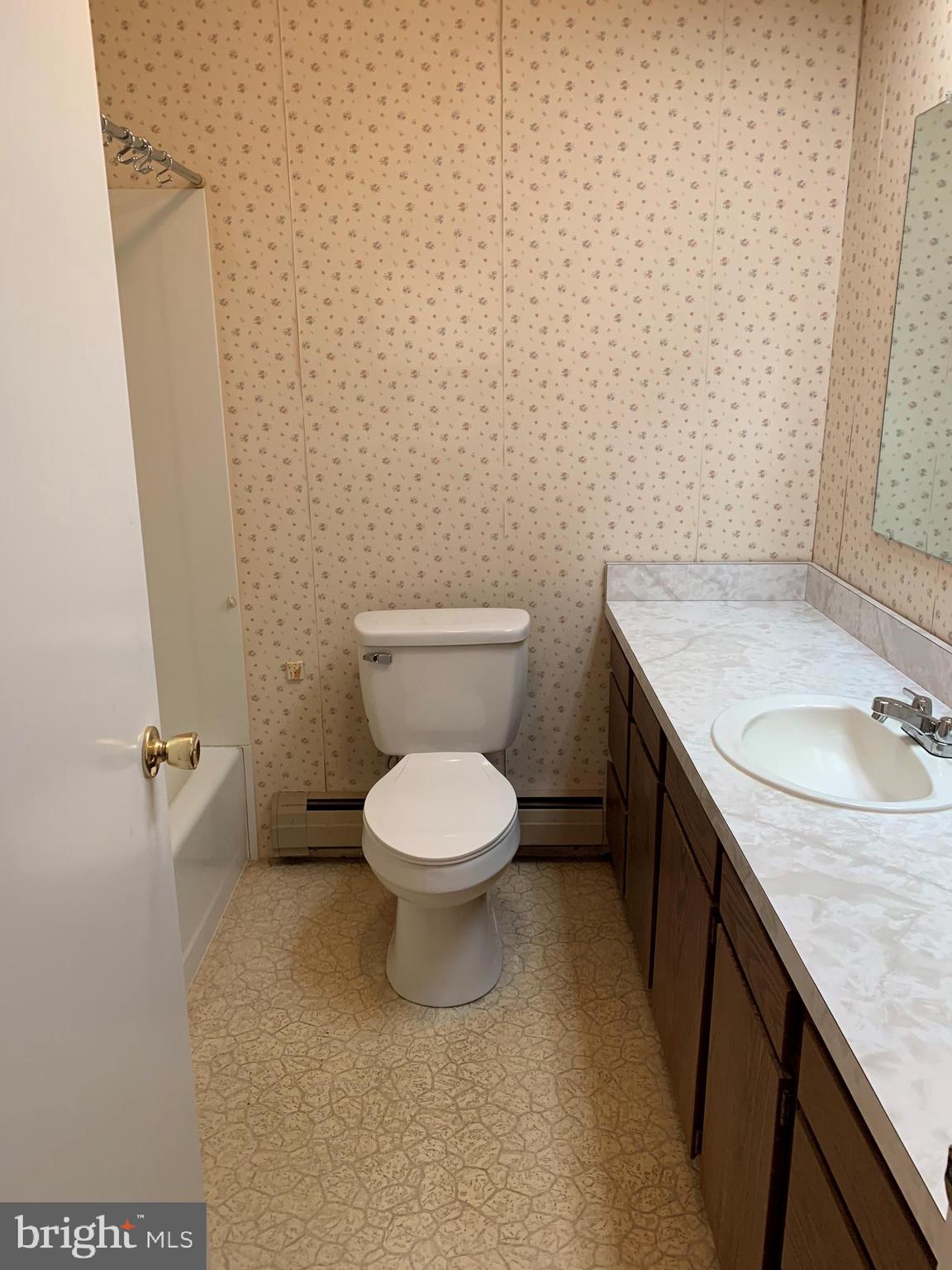 4515 Shirley Gate Road Fairfax, VA 22030 - Photo 25 of 26 a bathroom with a granite countertop toilet and a sink