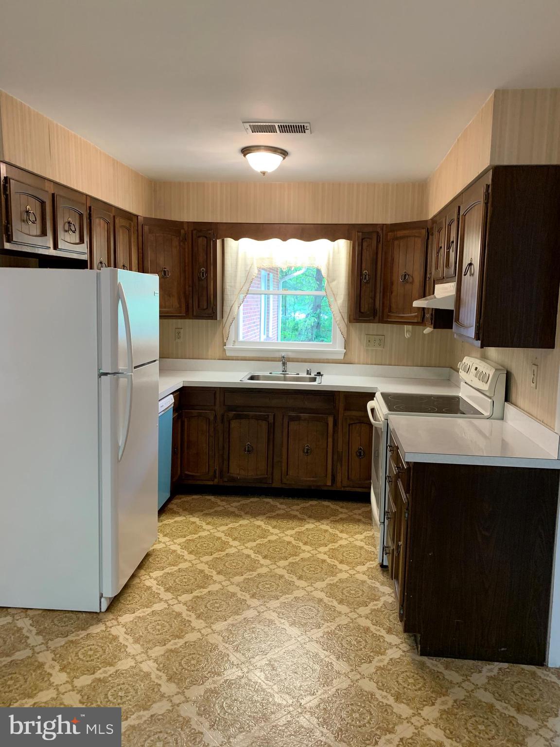 4515 Shirley Gate Road Fairfax, VA 22030 - Photo 10 of 26 a kitchen with stainless steel appliances a sink and a refrigerator