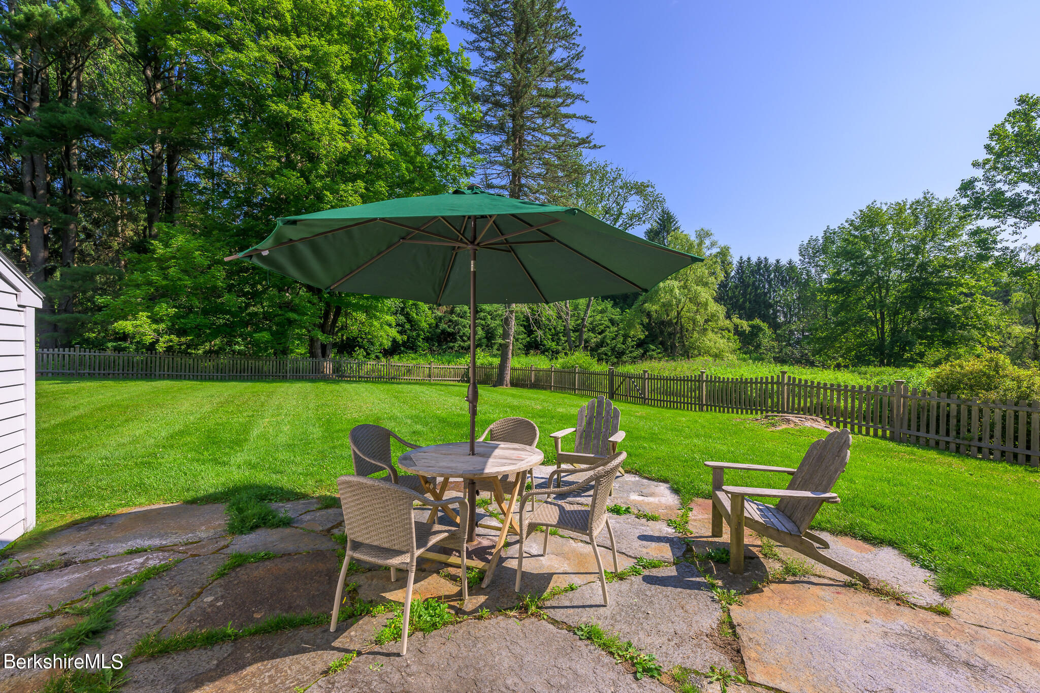 4 Austerlitz Road West Stockbridge, MA 01266 - Photo 17 of 42 a view of a table and chairs under an umbrella